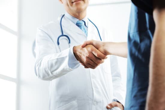 A clinician shaking hands with a patient at the start of an appointment